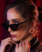 Amusement hoop earrings featuring an alternating pattern of smooth gold and hammered silver-tone segments.