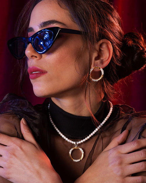 Mixed-metal Amusement pendant with gold and hammered silver textures on a white pearl strand necklace