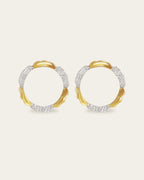 Amusement hoop earrings featuring an alternating pattern of smooth gold and hammered silver-tone segments.
