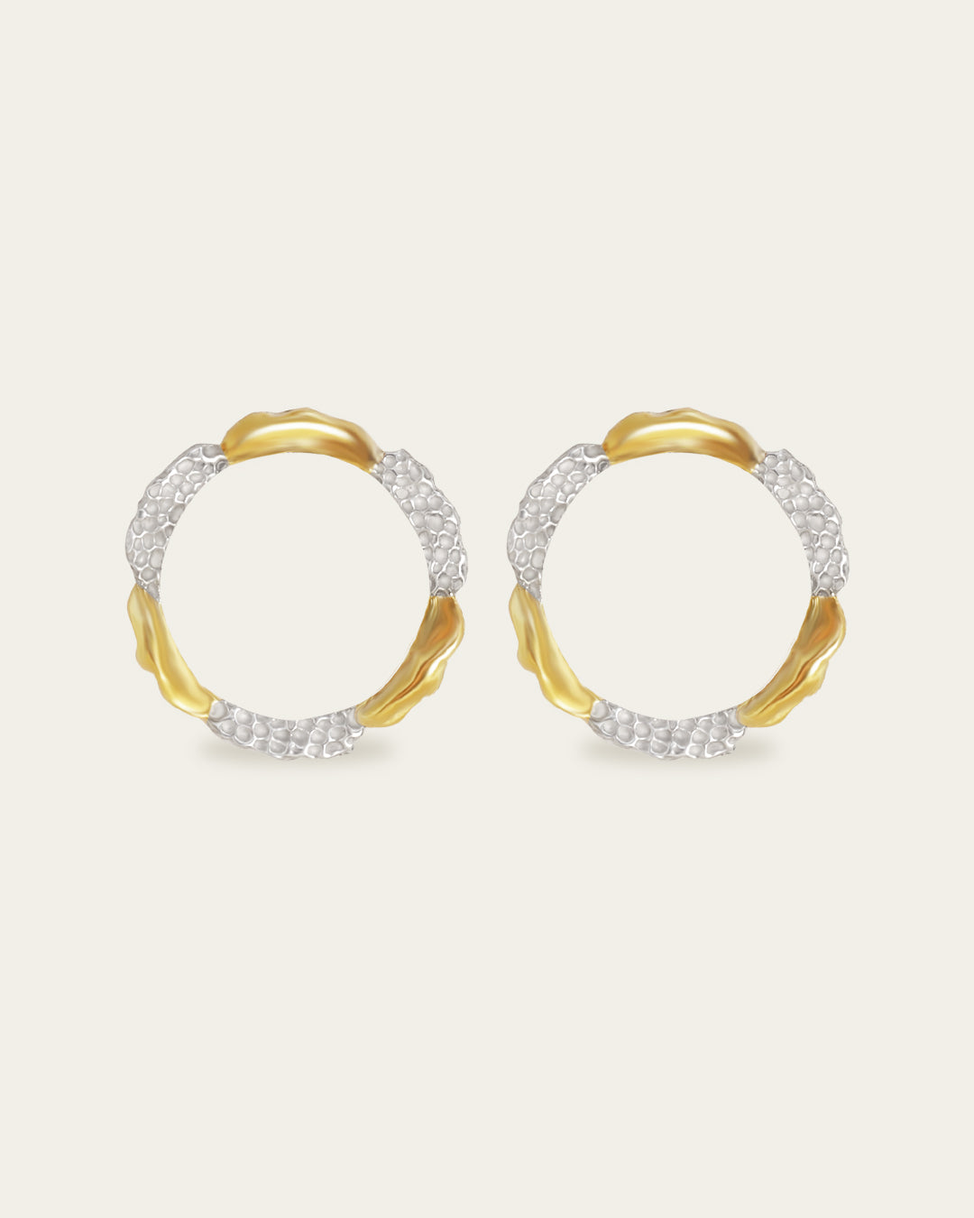 Amusement hoop earrings featuring an alternating pattern of smooth gold and hammered silver-tone segments.