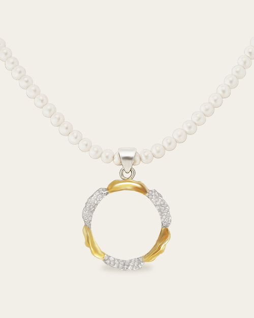 Mixed-metal Amusement pendant with gold and hammered silver textures on a white pearl strand necklace