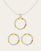 ASJ Amusement jewelry set flatlay. Handcrafted 18K gold and rhodium plated brass pendant necklace with pearls and matching earrings on white background.