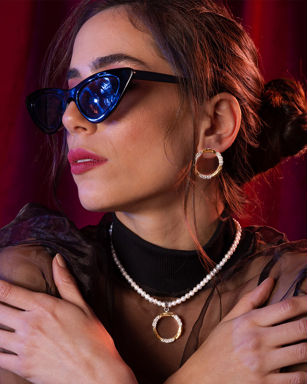 Woman wearing ASJ Amusement Set. Model in sunglasses styling the 18K gold and rhodium plated pearl choker and earrings with a chic evening look.
