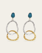Two-tone Attachment drop earrings with textured silver and gold oval links hanging from a teal blue stone