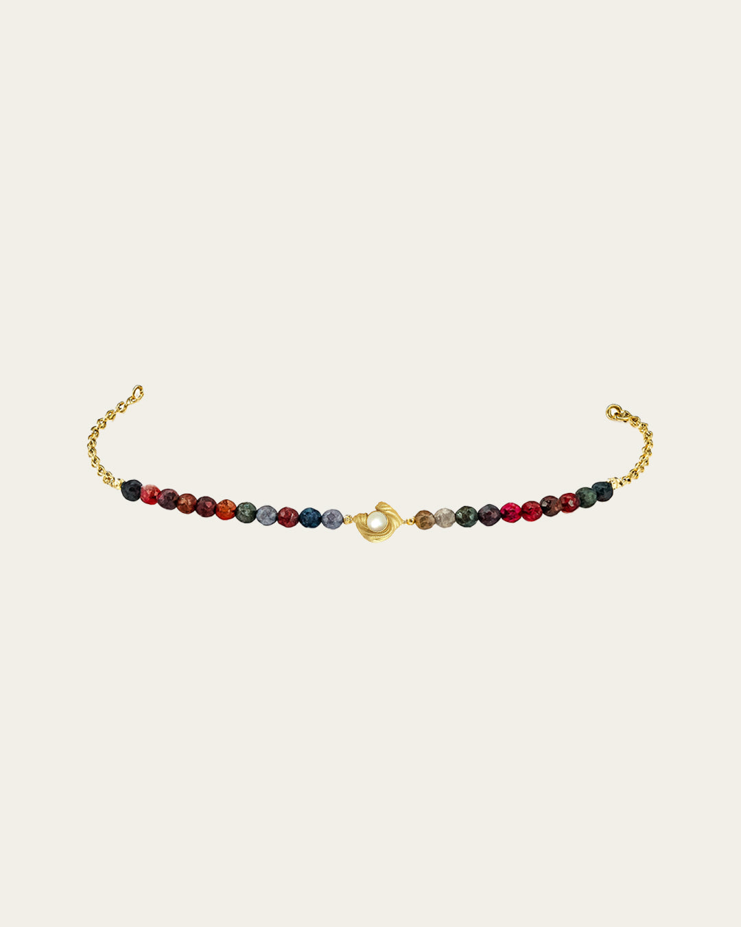 Glema bracelet featuring a line of multicolored agate beads in warm earth tones and a centered gold shell with a white seashell