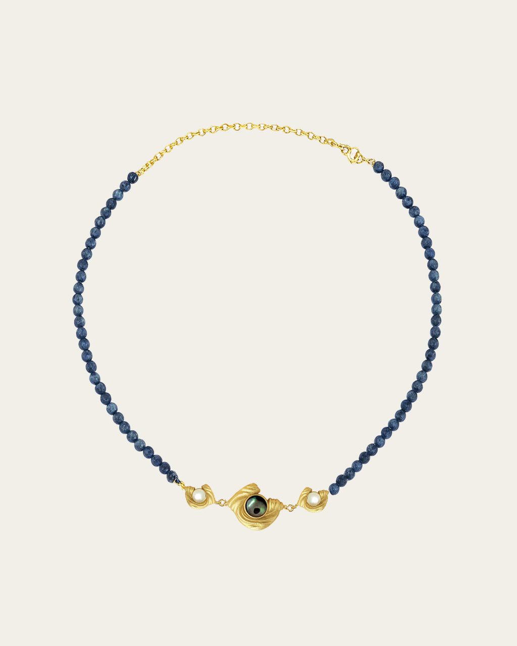 Glema teal bead choker featuring a triple gold charm arrangement with a central paua seashell and two white seashell stones.
