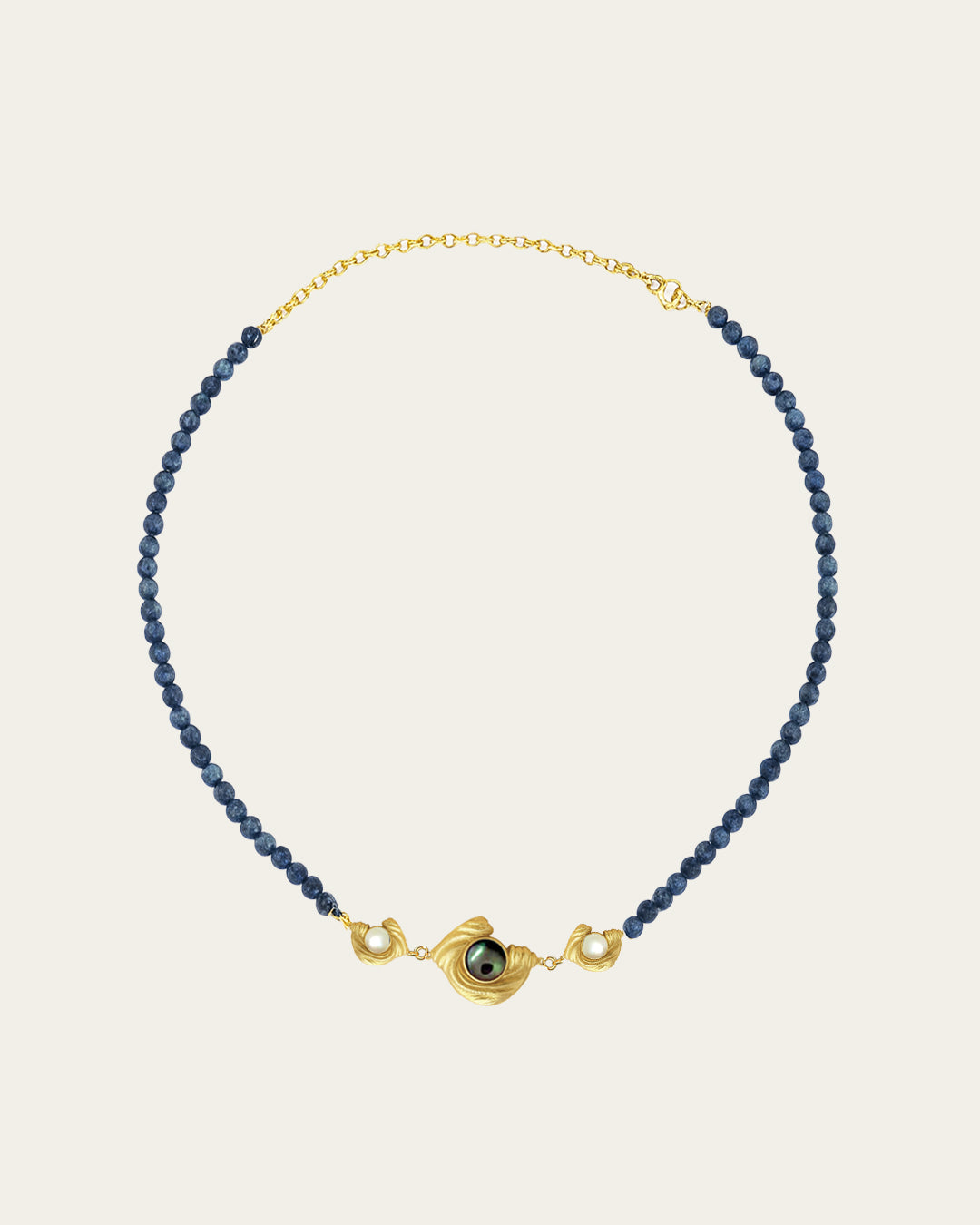 Glema teal bead choker featuring a triple gold charm arrangement with a central paua seashell and two white seashell stones.