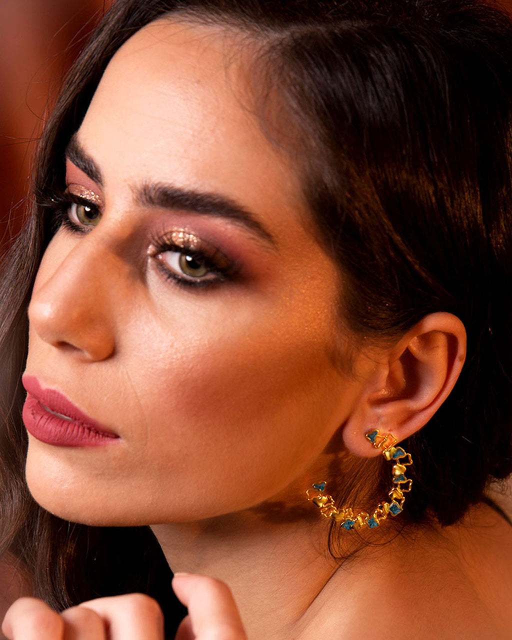 Statement gold Ripple hoop earrings with a textured, open-work design and blue enamel accents.