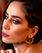 Statement gold Ripple hoop earrings with a textured, open-work design and blue enamel accents.