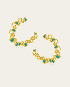 Statement gold Ripple hoop earrings with a textured, open-work design and blue enamel accents.