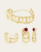 Textured gold Suhail earrings and cuff set with vibrant red gemstone accents in a handcrafted organic design.