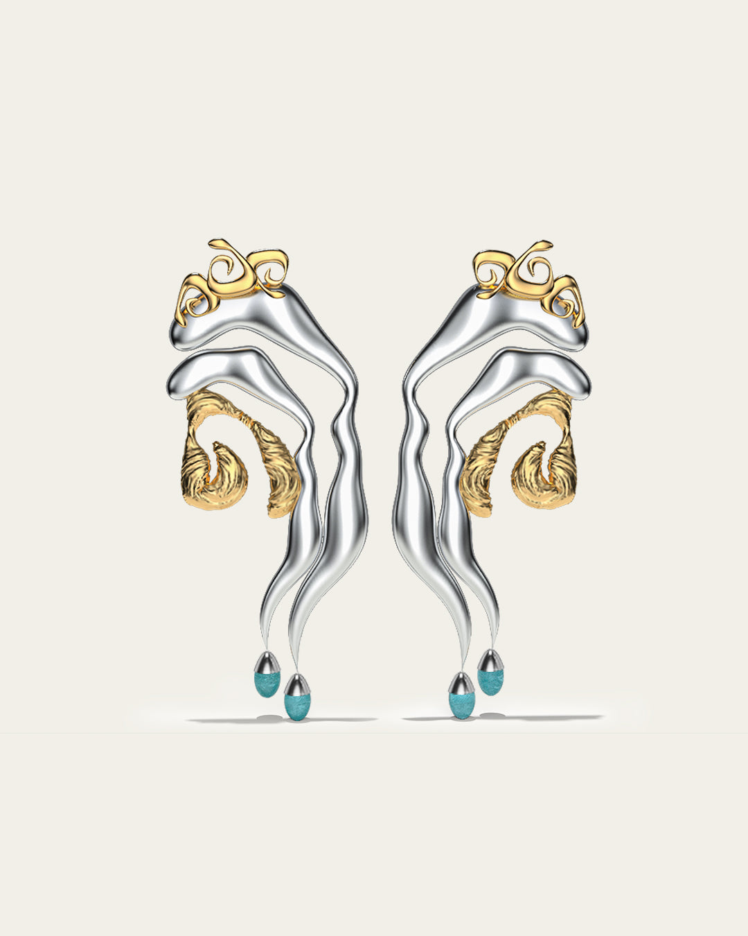 Mixed metal Tide statement earrings in gold and silver with an organic wave design and baby blue stone drops.