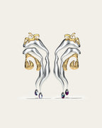 Mixed metal Tide statement earrings in gold and silver with an organic wave design and gradient blue stone drops.