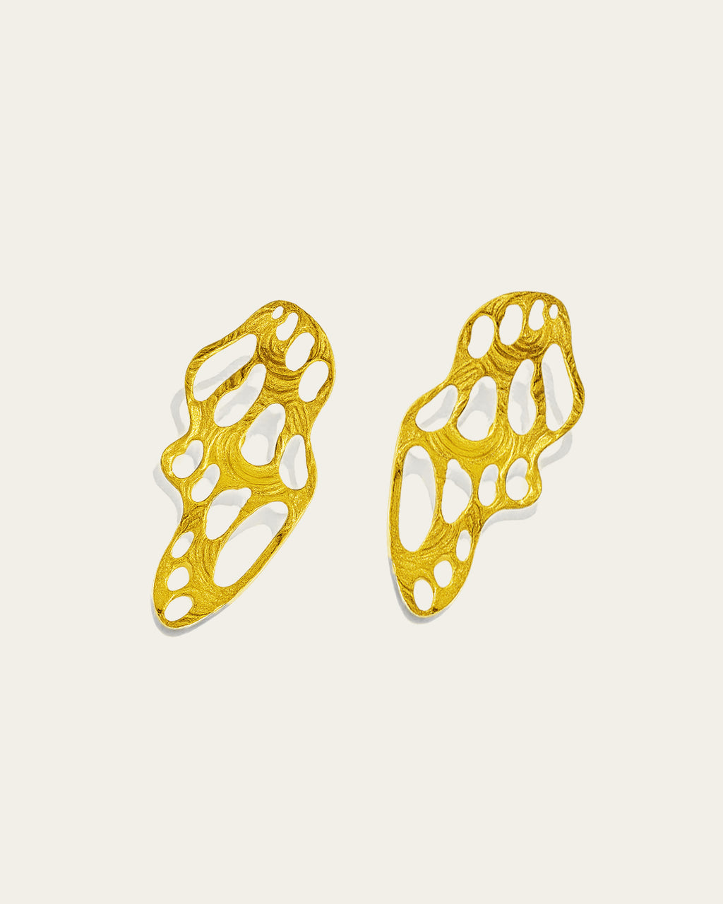 Waves earrings by Ann Elsaban Jewelry in 18K gold-plated, sculptural wave-inspired earrings with fluid organic lines and a polished finish, worn as an elegant statement piece