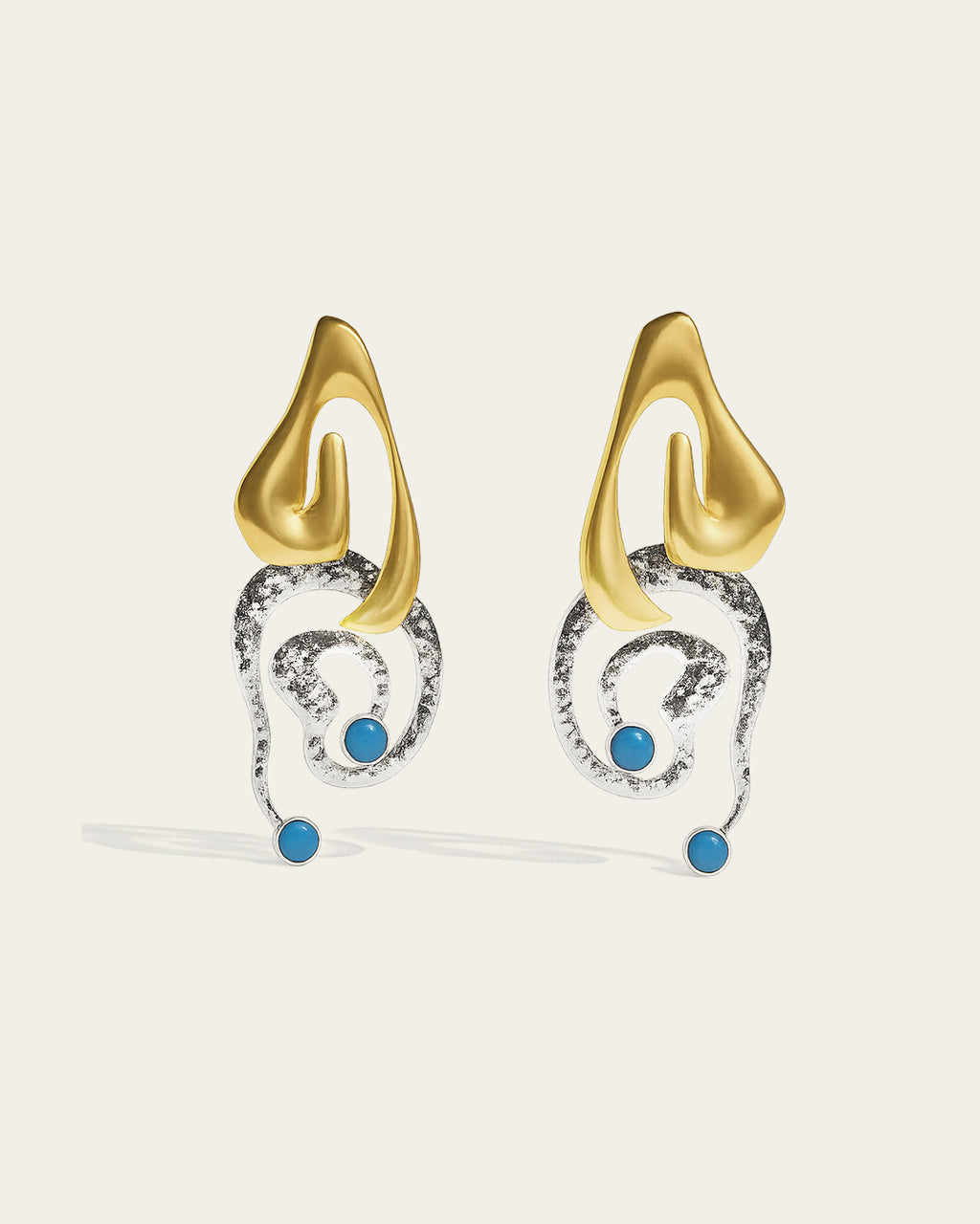 Clyra gold plated earrings featuring an elegant curved design with a high-polish finish and organic texture.