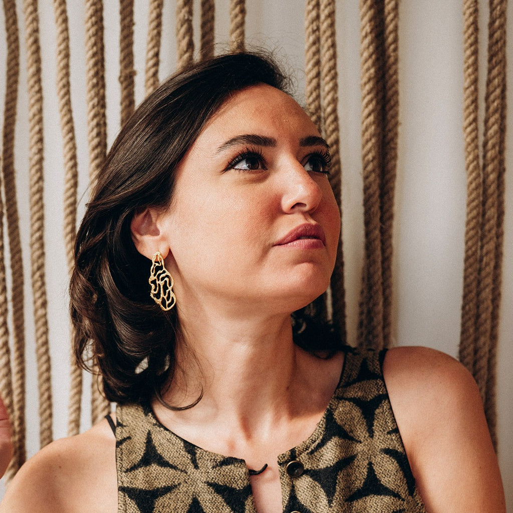 Coral earrings by Ann Elsaban Jewelry in 18K gold-plate, organic coral-inspired sculptural earrings with fluid forms and a polished finish, worn as an elegant statement piece