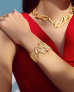 Handcrafted gold Ghosoun set including a statement branch collar necklace and an intricate textured open cuff