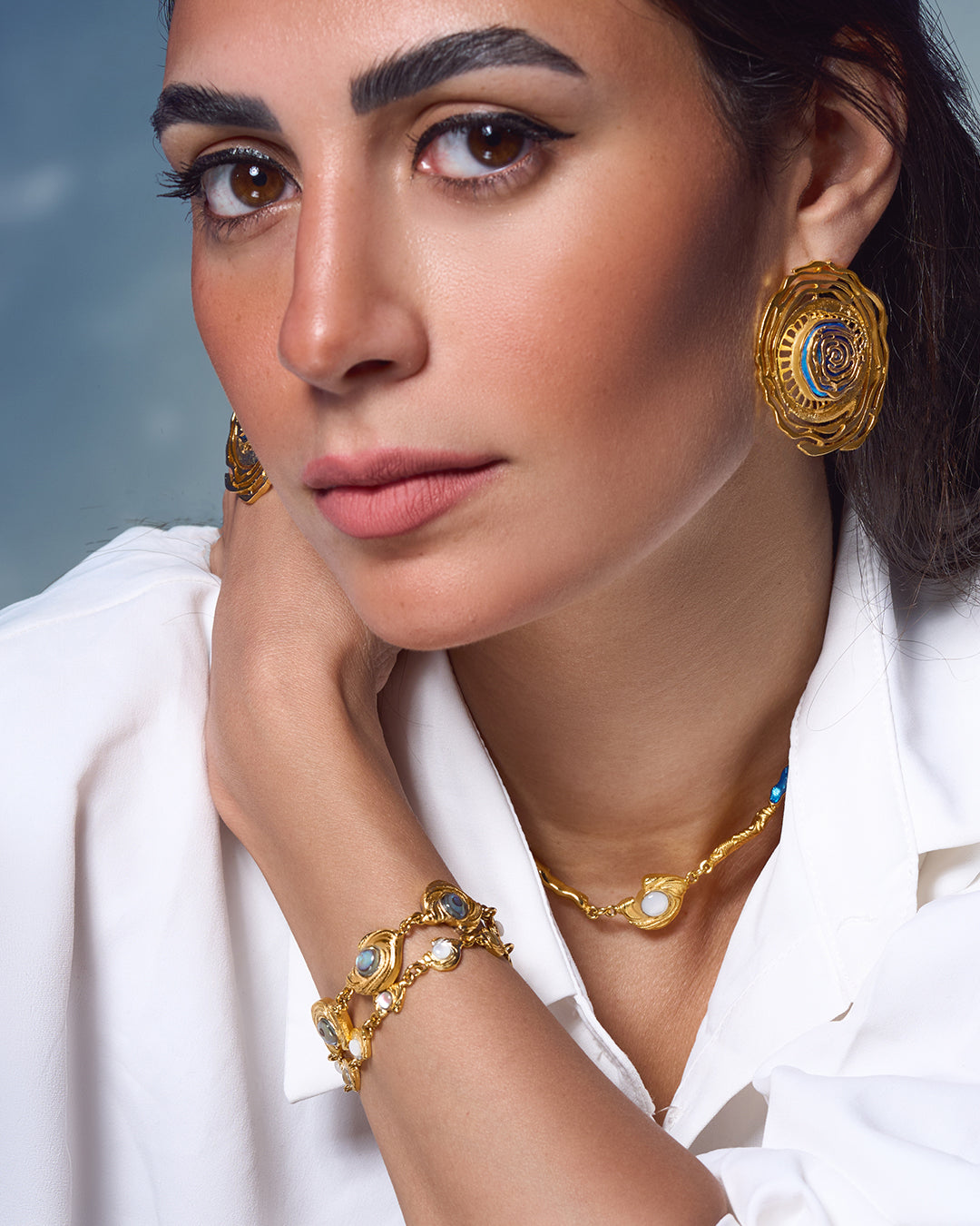 Statement Glema beaded bracelet in 18k gold plated metal with a signature pearl-and-shell focal point