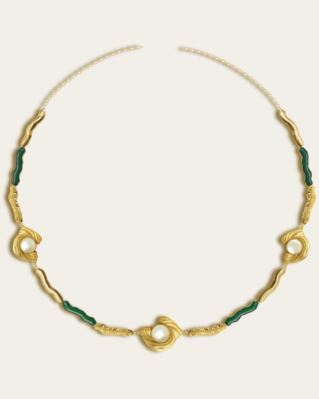Glema necklace featuring earth-toned green resin and a central textured gold charm with a seahell stone