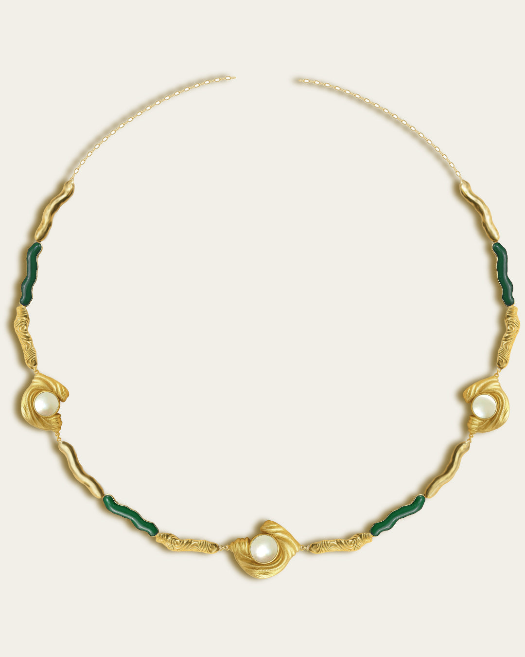 Glema necklace featuring earth-toned green resin and a central textured gold charm with a seahell stone