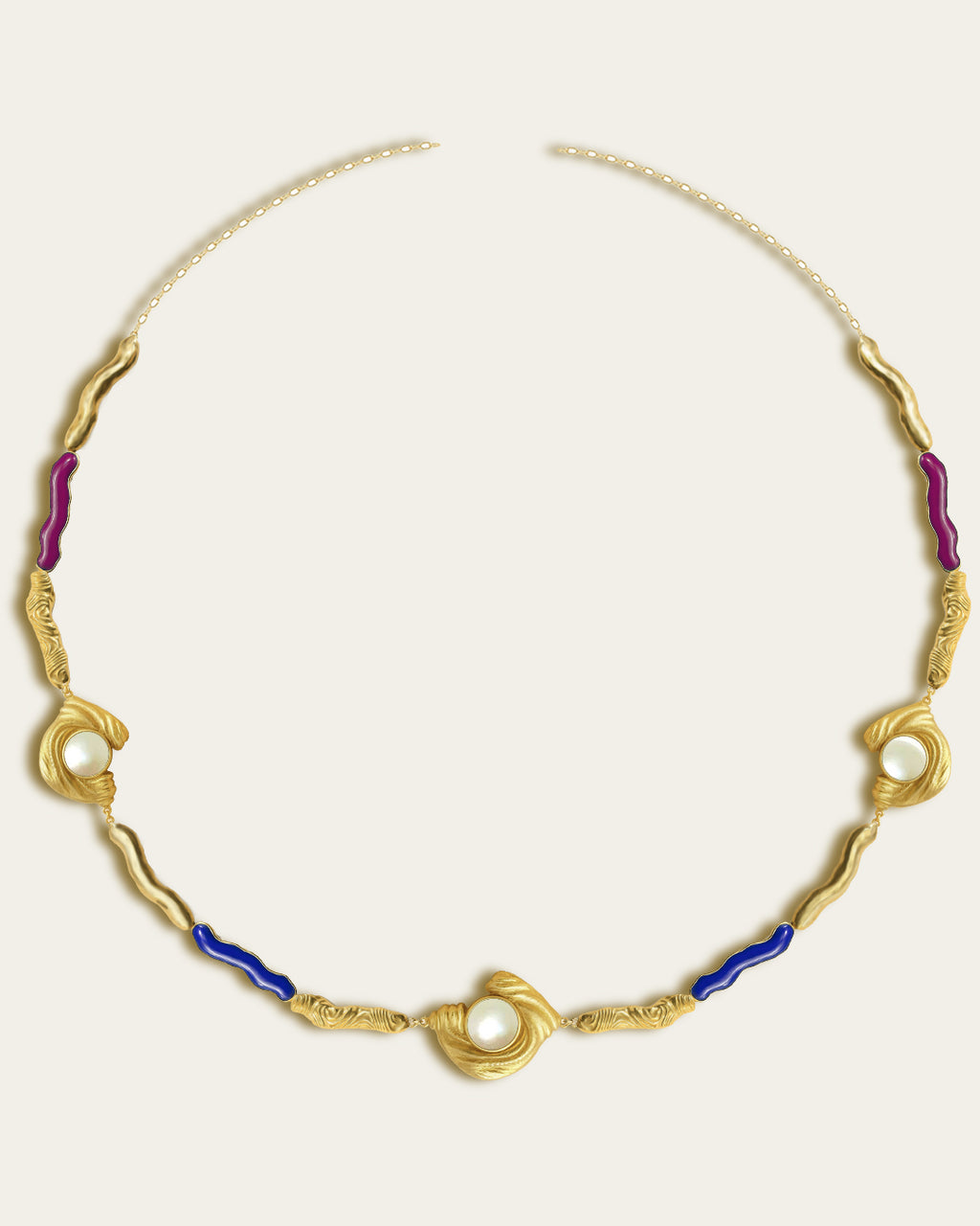 Glema necklace featuring earth-toned blue, magenta resin and a central textured gold charm with a seahell stone