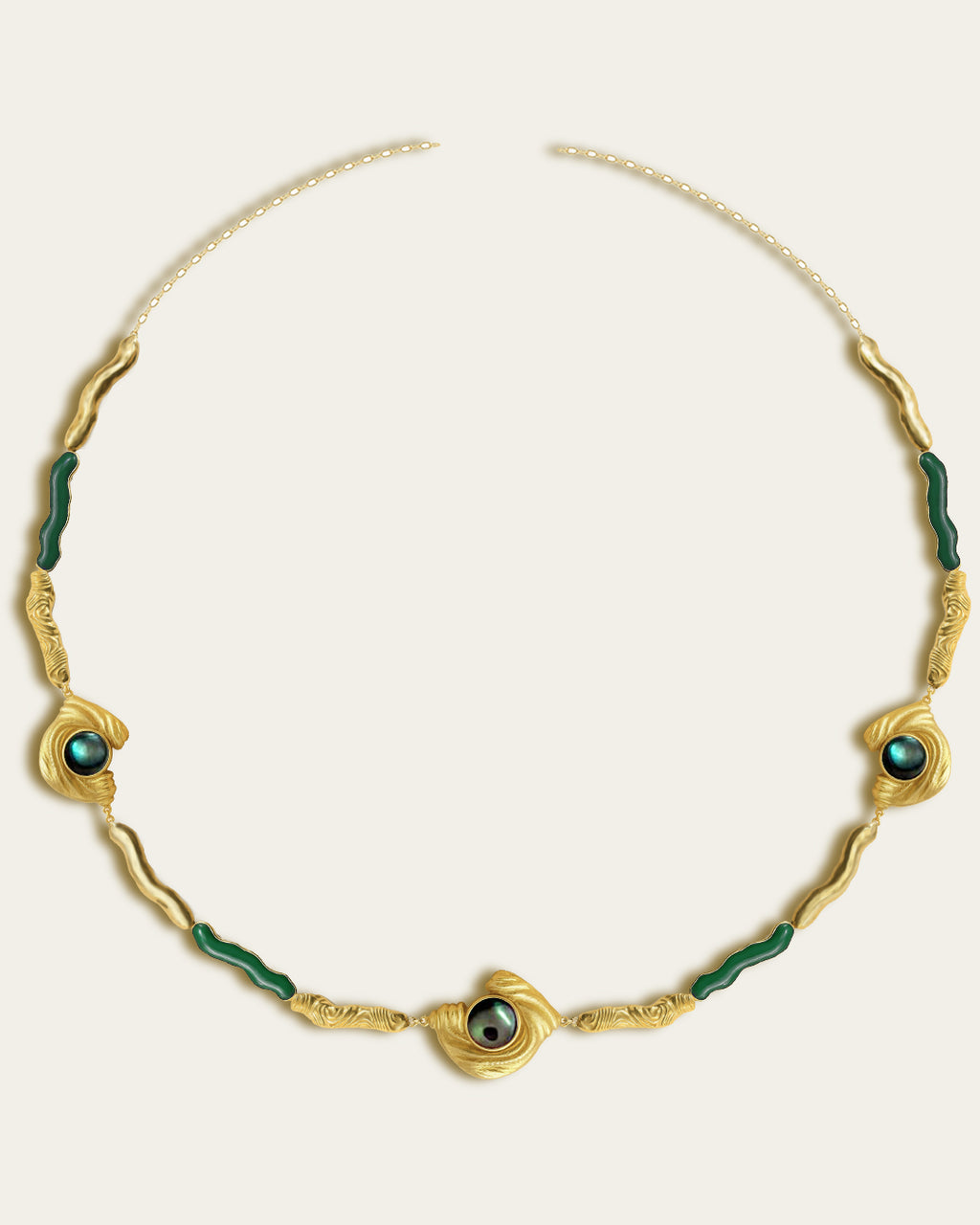 Glema necklace featuring earth-toned green resin and a central textured gold charm with a paua seahell