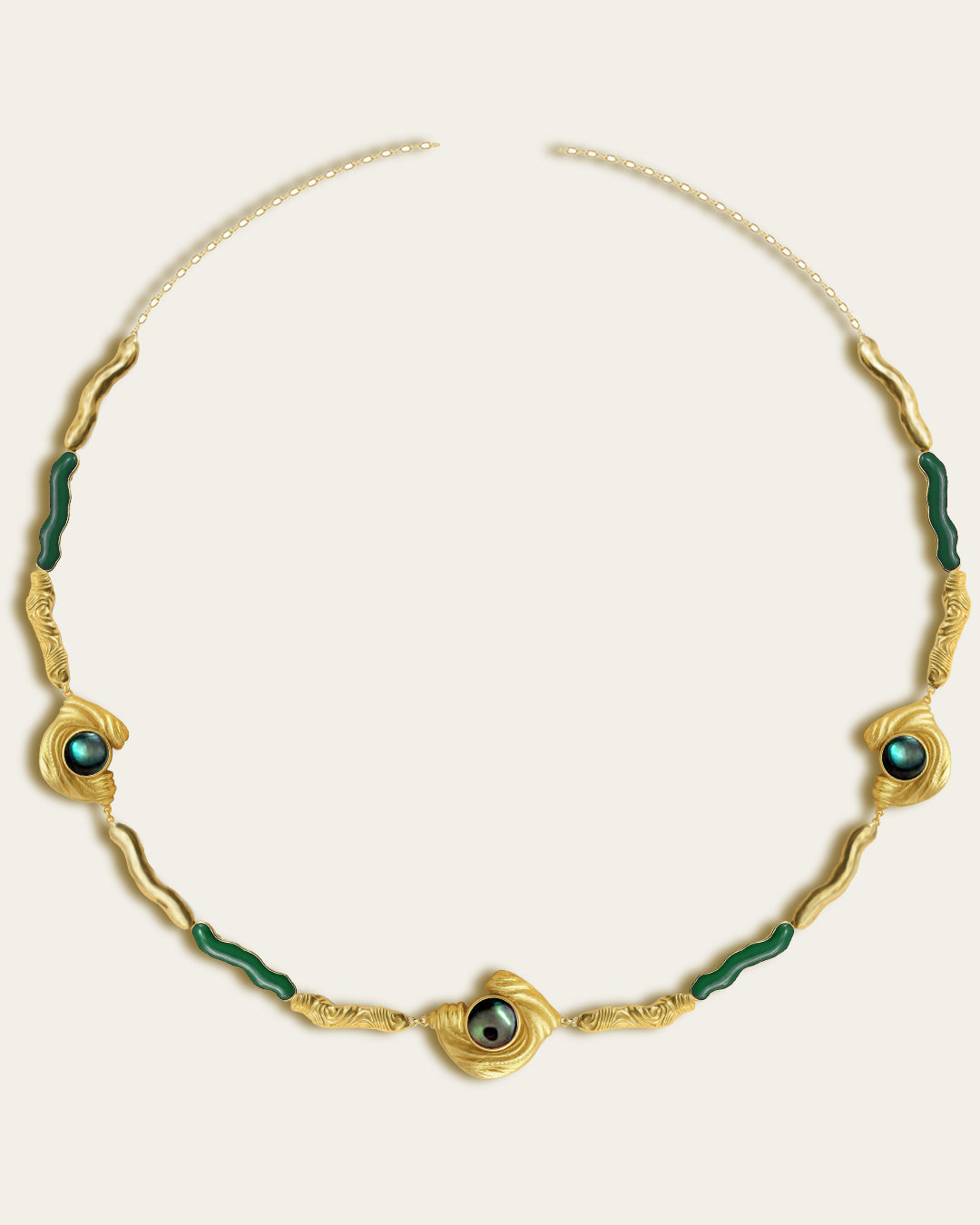 Glema necklace featuring earth-toned green resin and a central textured gold charm with a paua seahell