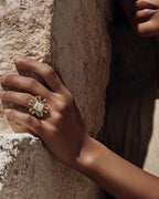 Hand wearing Statement Sterling silver gold Legend hoops with a bold chunky silhouette and a luxurious handcrafted texture Eye of Horus earrings with protective symbolism 