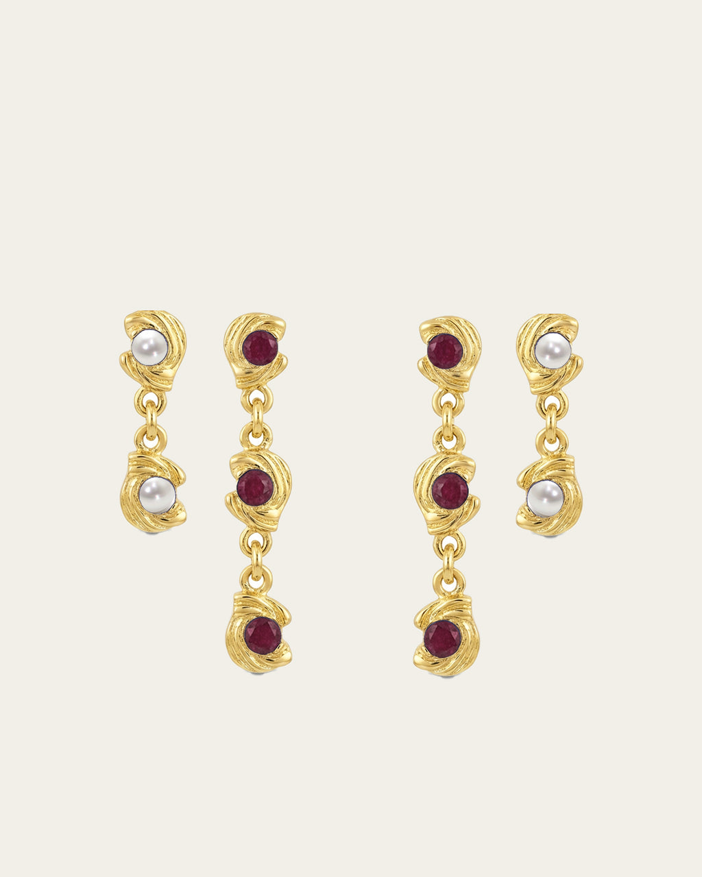 Mini Glema earrings stack in 18K gold-plated brass with red stones and white seashell details, shown as a coordinated drop-earring bundle with built-in 15% discount.