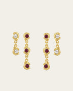Mini Glema earrings stack in 18K gold-plated brass with red stones and white seashell details, shown as a coordinated drop-earring bundle with built-in 15% discount.