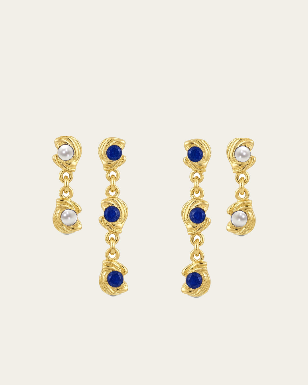 Mini Glema earrings stack in 18K gold-plated brass with blue stones and white seashell details, shown as a coordinated drop-earring bundle with built-in 15% discount.