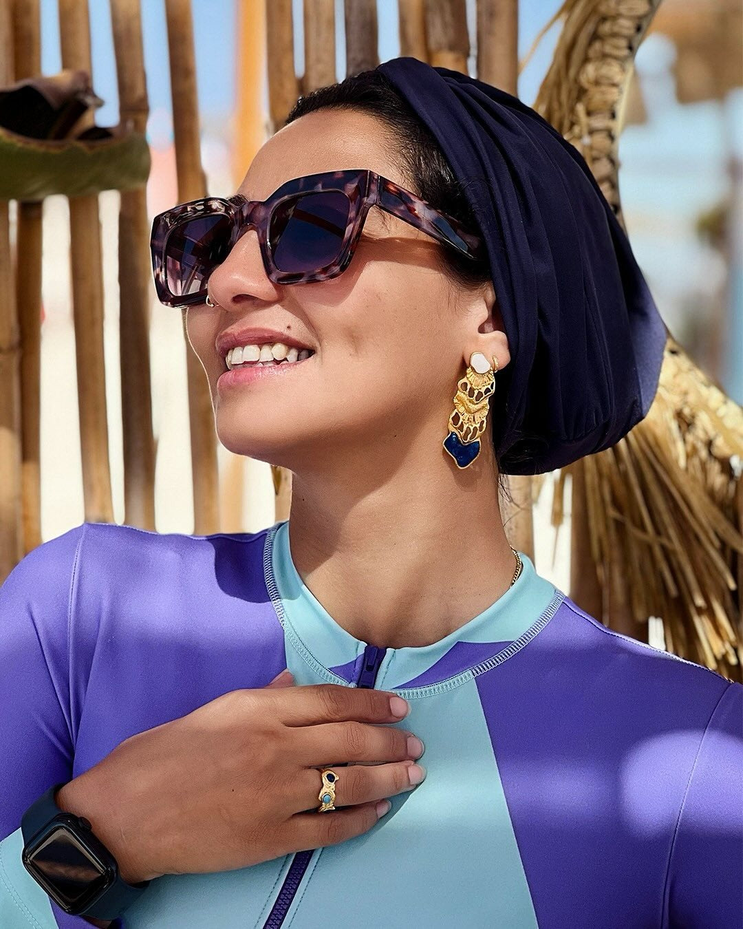 Oceantica earrings, sculptural ocean-inspired earrings with fluid organic lines and a polished finish, worn as an elegant statement piece