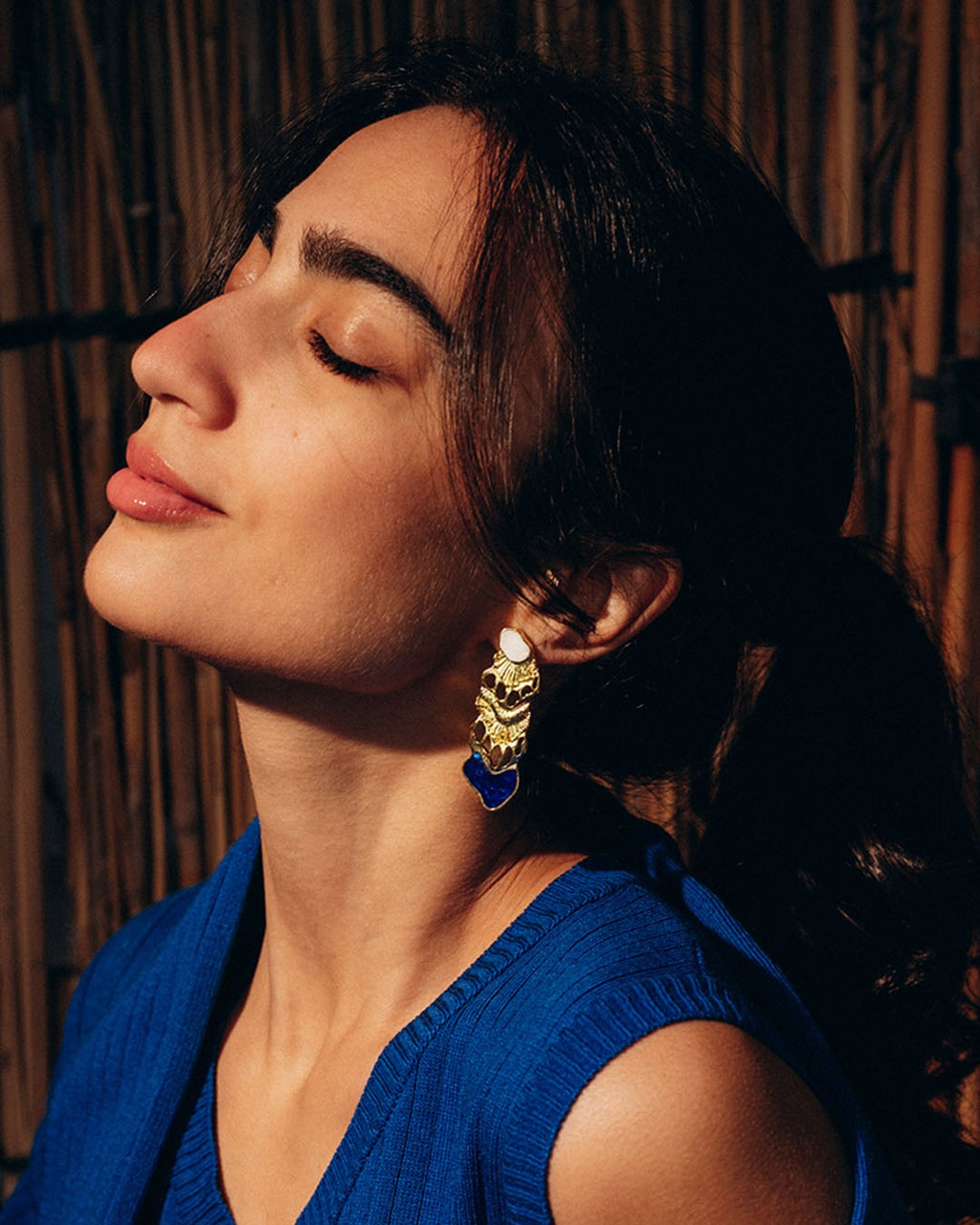 Oceantica earrings, sculptural ocean-inspired earrings with fluid organic lines and a polished finish, worn as an elegant statement piece