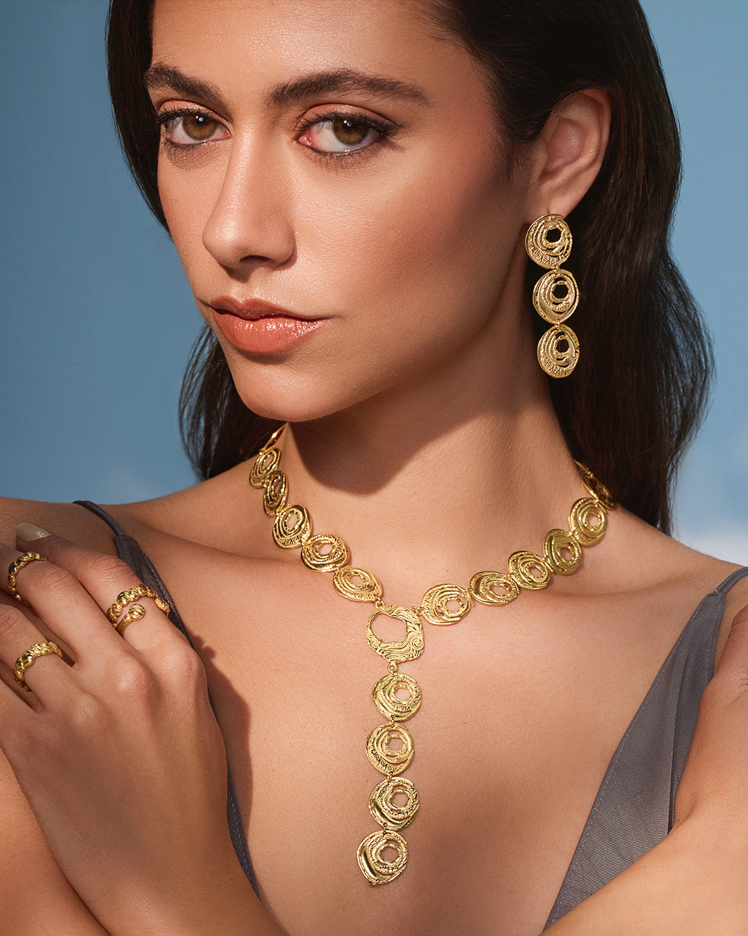 Textured 18k gold Qamar set with a celestial-inspired drop necklace and dangling circular statement earrings.