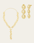 Textured 18k gold Qamar set with a celestial-inspired drop necklace and dangling circular statement earrings.