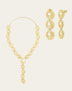 Textured 18k gold Qamar set with a celestial-inspired drop necklace and dangling circular statement earrings.