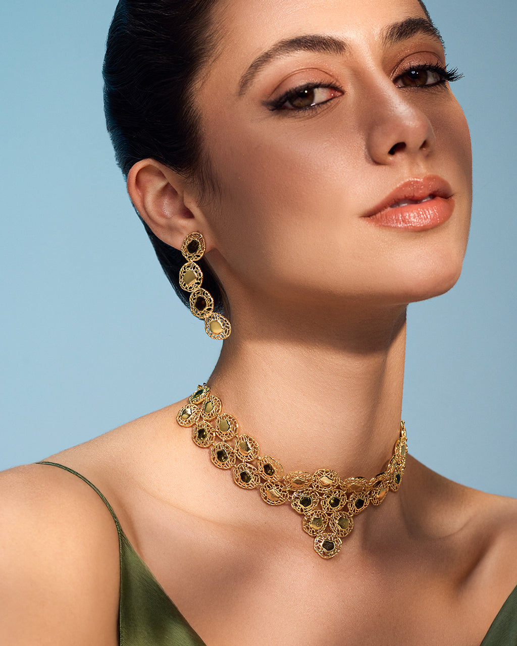 Gold Sheftesh filigree necklace and earring set with red stone details in a geometric honeycomb pattern