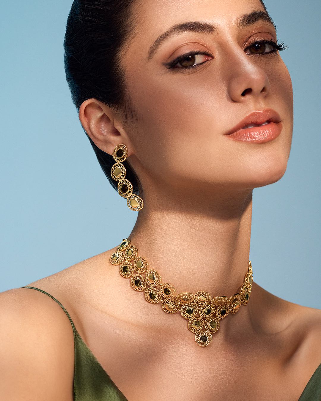 Gold Sheftesh filigree necklace and earring set with red stone details in a geometric honeycomb pattern