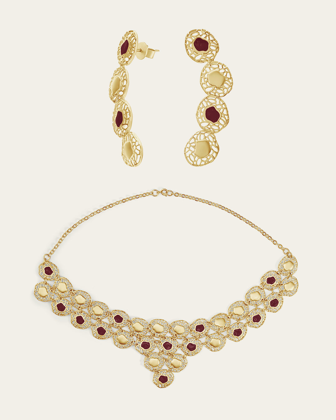 Gold Sheftesh filigree necklace and earring set with red stone details in a geometric honeycomb pattern