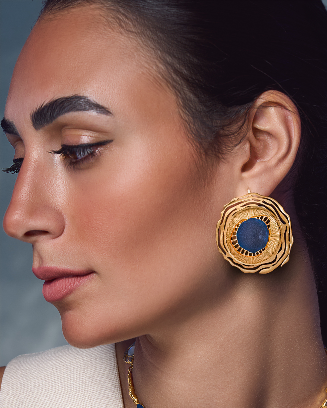 Swirl 18k gold plated jewelry set featuring dynamic spiral designs and a textured gold finish