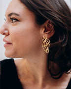 Waves earrings by Ann Elsaban Jewelry in 18K gold-plated, sculptural wave-inspired earrings with fluid organic lines and a polished finish, worn as an elegant statement piece